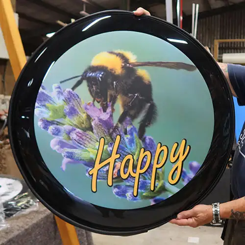 Dog wheelcover on customers Defender. Bee Happy Wheel Cover