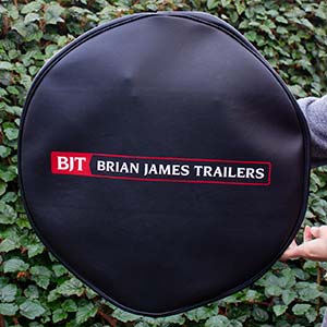 Screen printed soft wheel cover for a trailor.